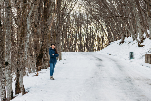 young woman walking in snow