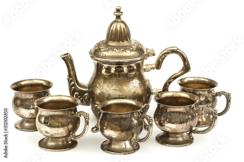 Set of silver dishes for tea or coffee Isolated on a white background. Silver tea or coffee set of utensils on a white background.