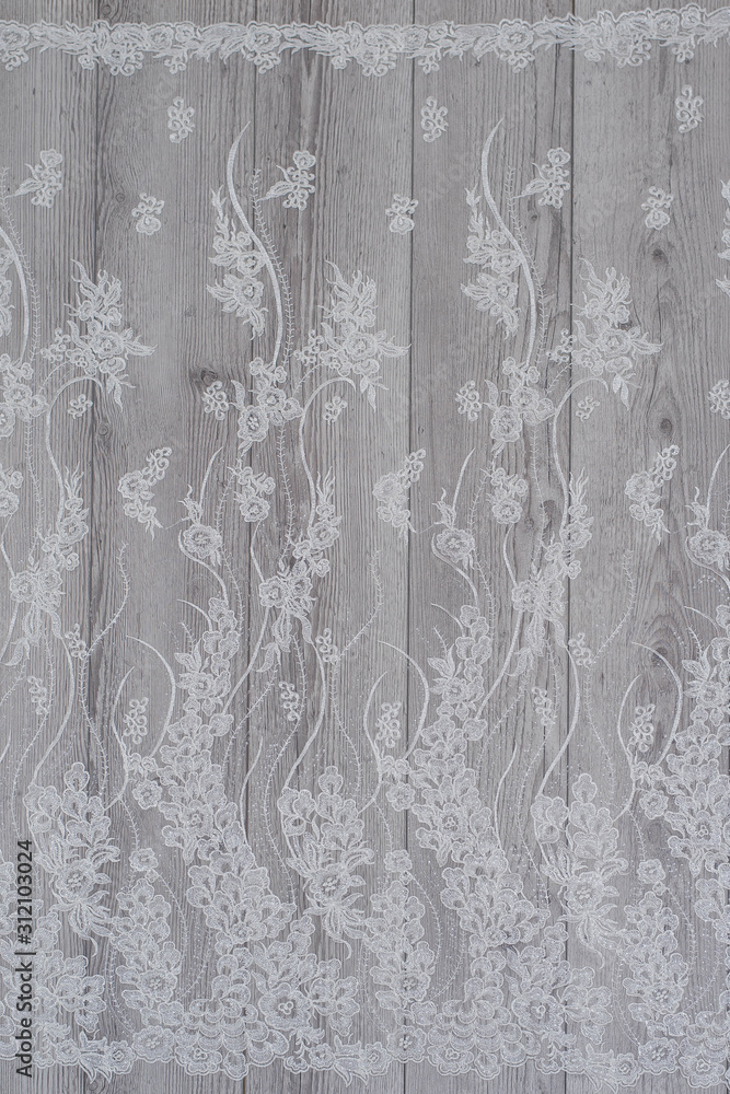 Fototapeta premium White wooden background with white spring flowers roses and lace ribbon. Happy womans day. The texture of lace on wooden background.