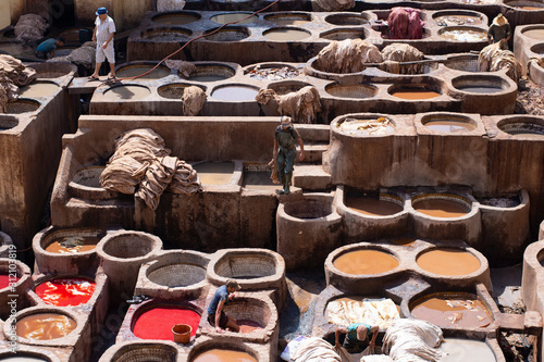 Fes, Morocco - October 3 2019: View of workers dying leather in the historic tanneries © caz_che