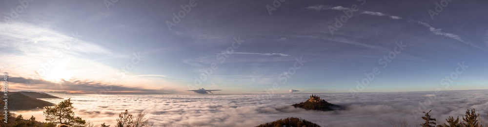 Hohenzollern castle above the clouds fog wide panorama