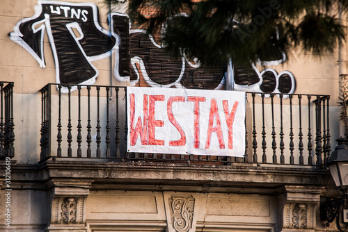 Residential building is occupied by unauthorized squatters and transformed into illegal squat. Anarchist hand-written banner from the window. photo