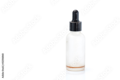 Empty transparent vape liquid bottle with residue isolated on the white background
