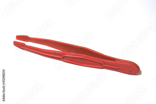 plastic tweezers on a white background