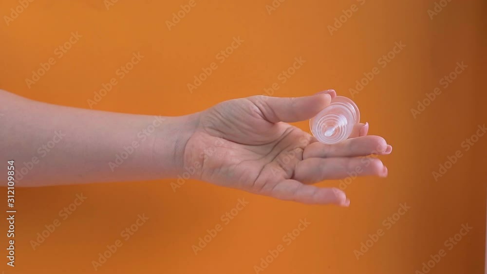 latex menstrual Cup in a woman's hand, an alternative hygiene product for women during the menstrual period. latex menstrual Cup in a woman's hand, an alternative hygiene product for women during the menstrual period.