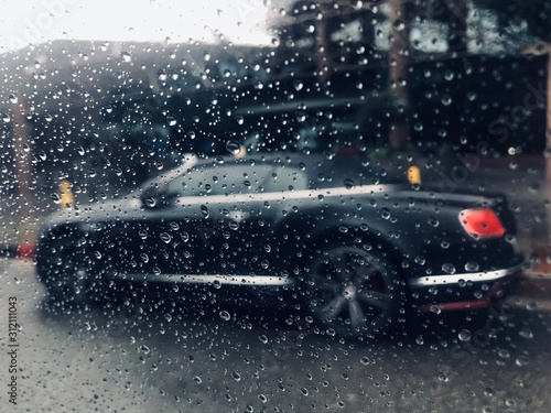 Water droplets on window overlooking car
