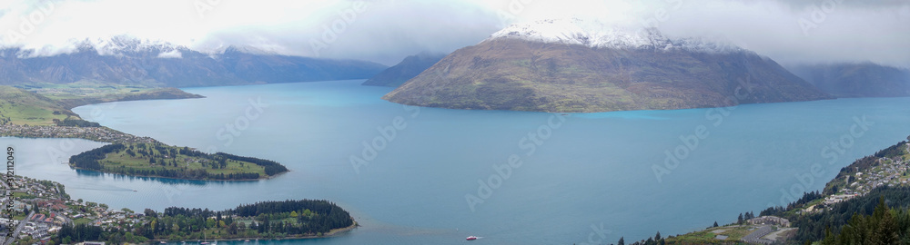 View over Queenstown Bay and Cecil Peak under cloudy skies in the South Island of New Zealand
