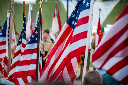 Multiple American flags are part of a Boy Scout Camp presentation. photo