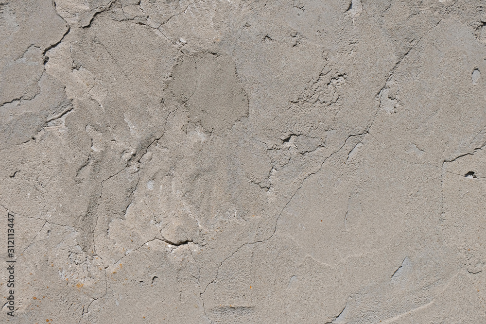 .Plastered wall of an old house with traces of weathering. Uneven gray surface. Grunge. Texture. Background. Copy space. .Plastered wall of an old house with traces of weathering. Uneven gray surface. Grunge. Texture. Background. Copy space.
