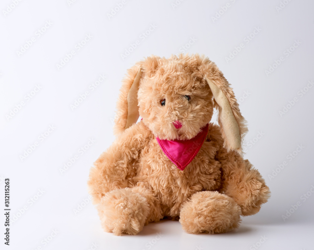 toy brown plush hare sitting on a white background