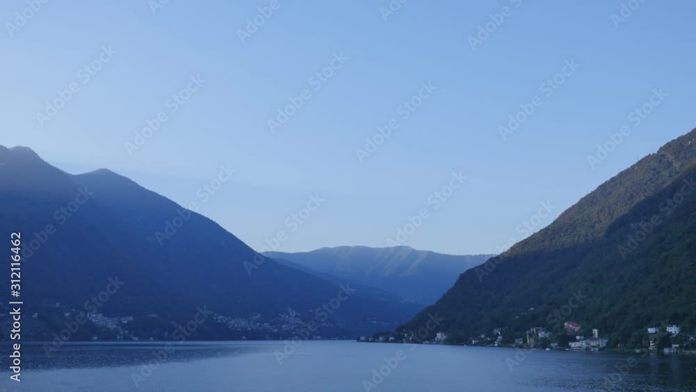 dawn mountains lake houses on the shore water slow motion dawn mountains lake houses on the shore water slow motion