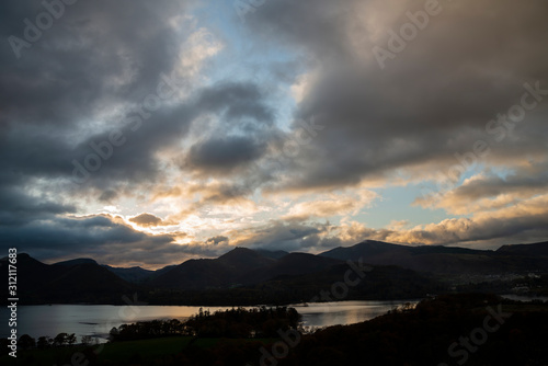 Majestic Autumn Fall landscape image of view from Castlehead in Lake District over Derwentwater towards Catbells and Grisedale Pike at sunset with epic lighting in sky photo