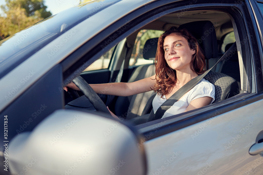 Woman driving through the mountains of Granada, Spain Woman driving through the mountains of Granada, Spain