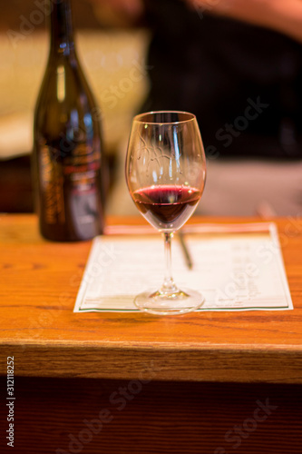 A glass of red wine at a wine tasting table