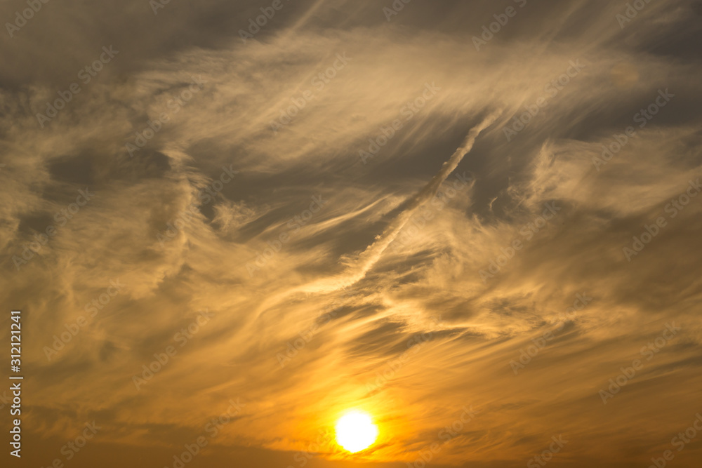 The sky lit with a setting sun cut by clouds. The sky lit with a setting sun cut by clouds.