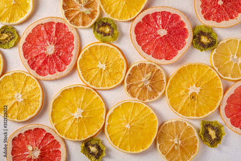 Creative food fruit texture with dried grapefruit, orange, kiwi and lemon on white background, top view Creative food fruit texture with dried grapefruit, orange, kiwi and lemon on white background, top view