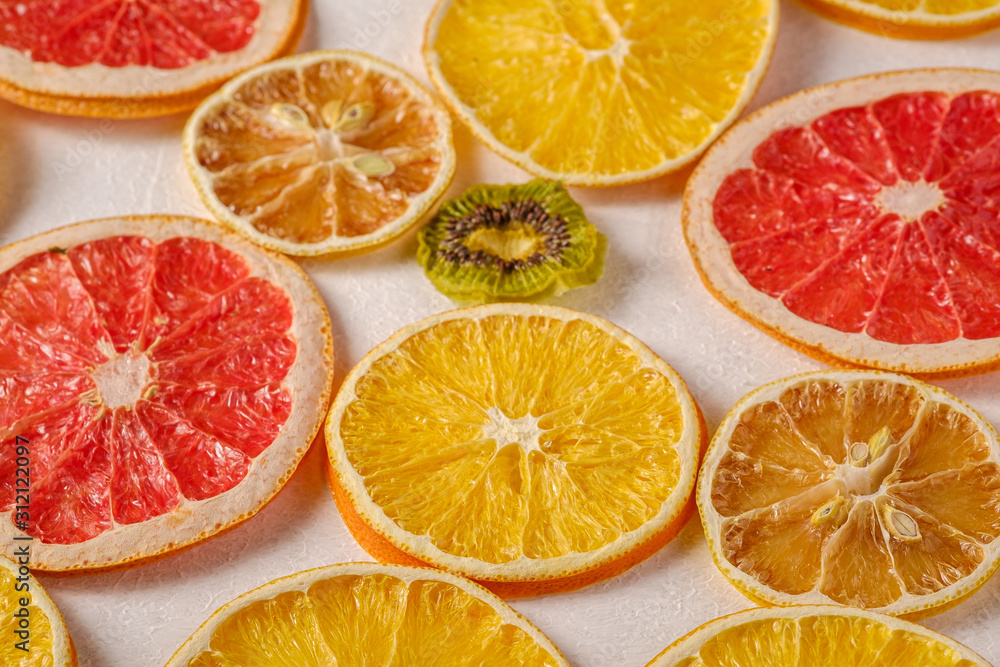 Creative food fruit texture with dried grapefruit, orange, kiwi and lemon on white background, angle view Creative food fruit texture with dried grapefruit, orange, kiwi and lemon on white background, angle view