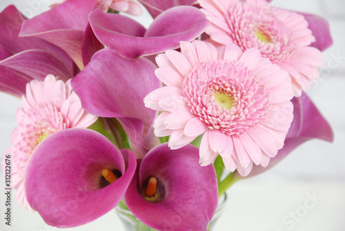 Springtime floral bouquet.  Pink calla lilies with pink Gerber daisies.