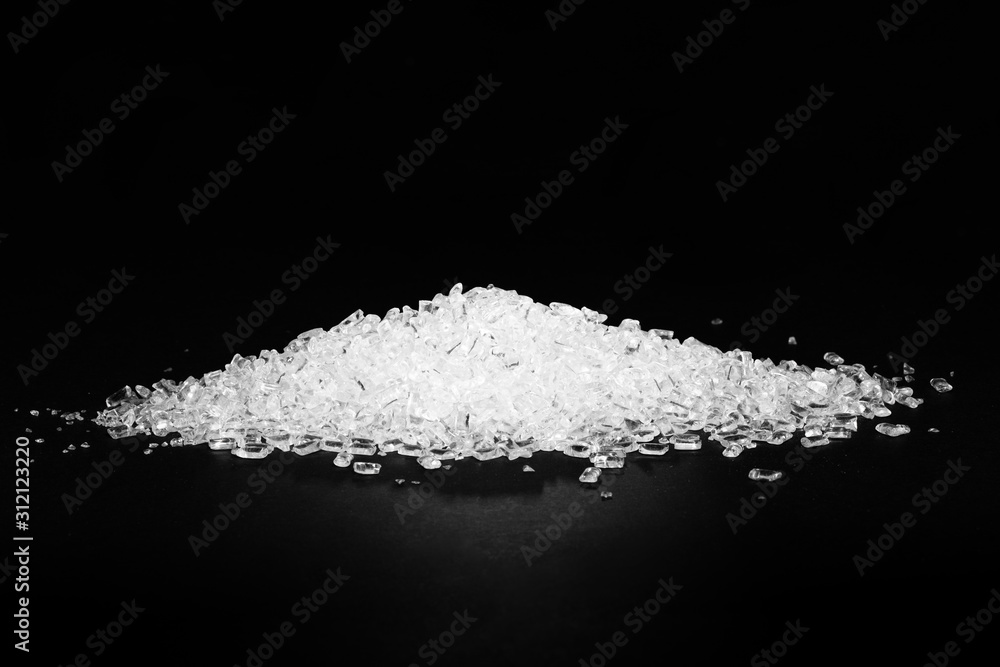 Transparent polypropylene granules plastic pellets material on black background