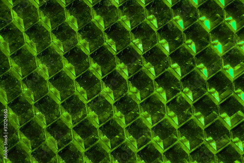 A close up abstract macro photo of a plastic reflector lit with a green flash gel photo