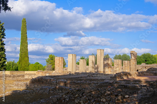 Old white columns and ruined square in ancient roman city Italica, Sevile, Spain photo