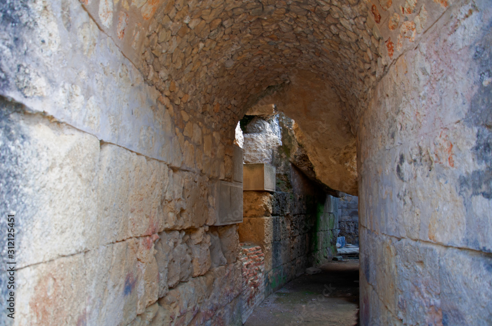 Old stone semicircular tunnel in ancient roman city Italica in Seville, Spain