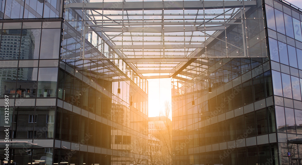Sun rays light effects on urban buildings in sunset. Modern office building detail, glass surface with sunlight. Business background. Sun rays light effects on urban buildings in sunset. Modern office building detail, glass surface with sunlight. Business background.