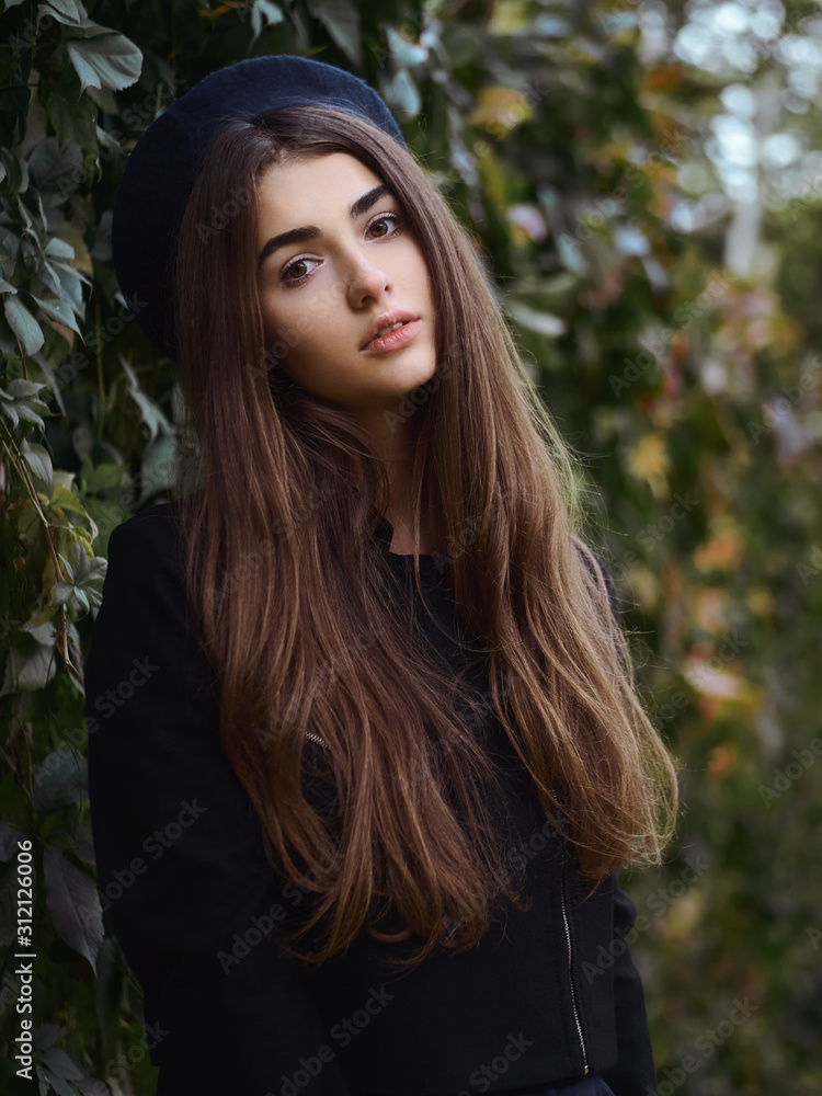 Mood contrasty portrait young elegant french style brown haired woman in beret and black leather jacket enjoying free time strolling in fall city park cinematic stock colour grading ivy background Mood contrasty portrait young elegant french style brown haired woman in beret and black leather jacket enjoying free time strolling in fall city park cinematic stock colour grading ivy background