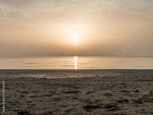 Sunrise at sand beach at Mediterranean sea