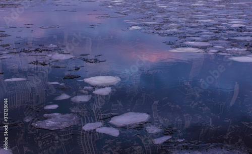 New York City underwater calm surface and floating sea ice magenta and orange reflections nobody