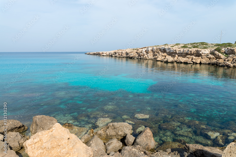 Curved rocky seashore and transparent water of Mediterranean sea