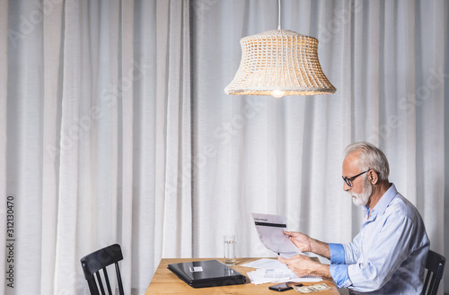 Fotografija Pensioner calculates the pension and bills