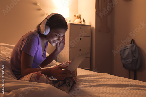 Teenage girl with laptop li...