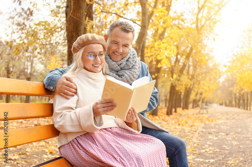 Happy mature couple reading...