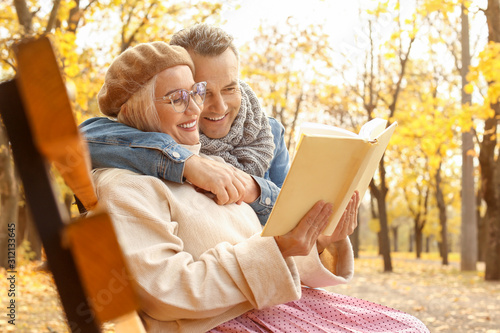 Happy mature couple reading...