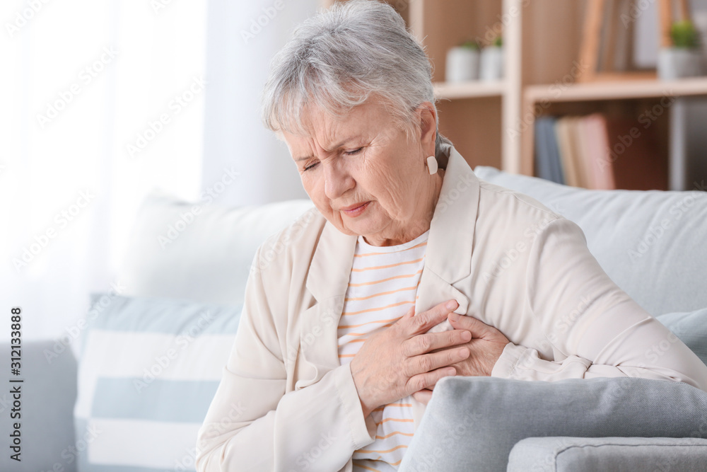 Senior woman suffering from heart attack at home Senior woman suffering from heart attack at home