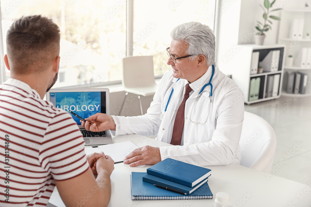 Young man visiting urologist in clinic Young man visiting urologist in clinic