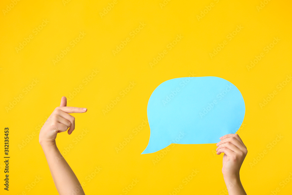 Female hands and blank speech bubble on color background - obrazy, fototapety, plakaty 