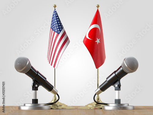 Microphones and  flags pair on a desk over isolated background.3d illustration