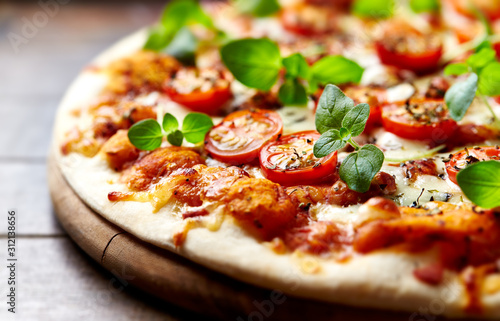 Vászonkép Tasty vegetarian pizza with cherry tomatoes, mozzarella cheese and fresh oregano