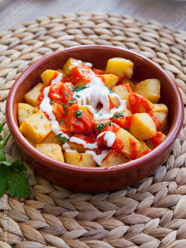 Spanish cuisine potato snack  -  patatas bravas. photo