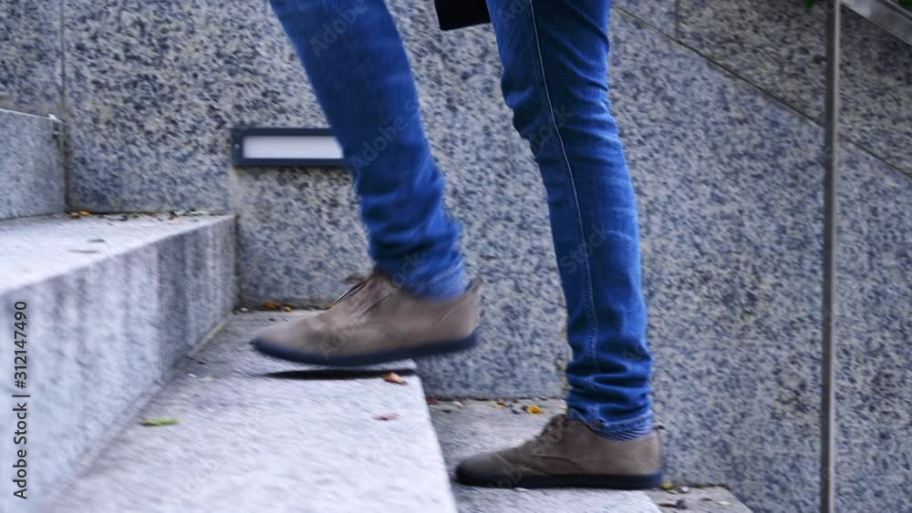 Walking upstairs, close-up view of man's leather shoes climbing up stairs . Walking upstairs, close-up view of man's leather shoes climbing up stairs .