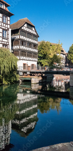 Reflections of timber framed houses and bridge in Strasbourg, France