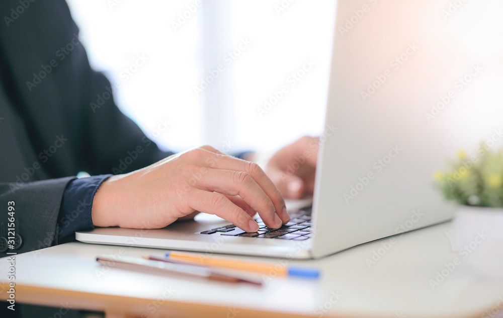 Businessman working with laptop computer at office. Businessman working with laptop computer at office.