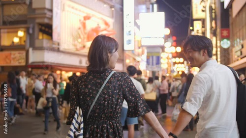 Wallpaper Mural Dreamy Asian couple Romantic walk through Neon Lights of Osaka Nightlife Torontodigital.ca