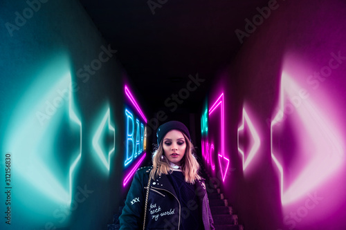 urban style girl walking down stairs to enter a nightclub bar