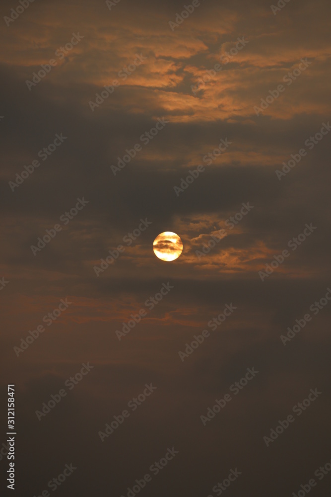 Fototapeta premium MORNING SUN SHINING BEHIND THE CLOUDS
