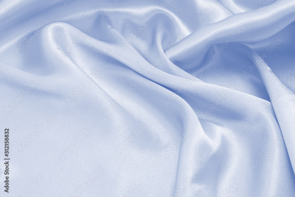 Fototapeta premium Draped satin blue fabric for festive backgrounds