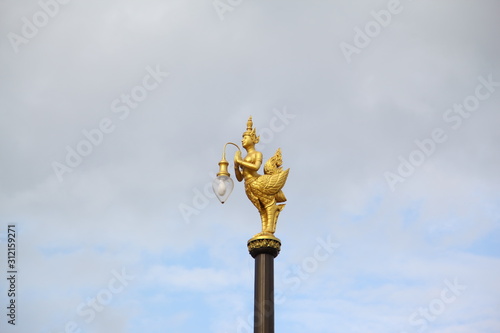 Golden bird lantern on the top of pole 
