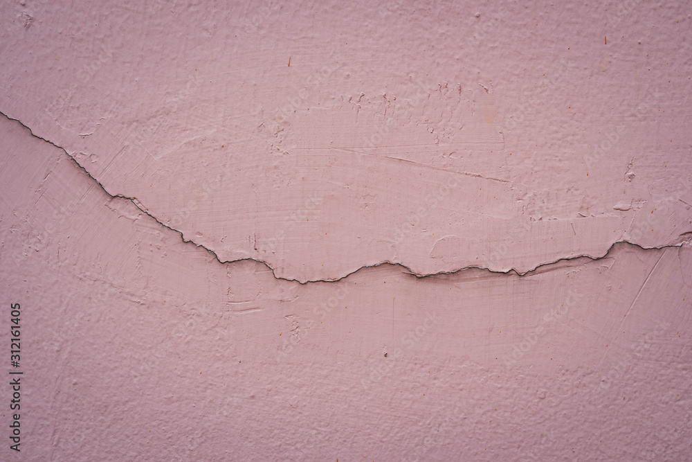 Fototapeta premium Dirty pink concrete wall background. Broken concrete wall background.